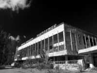 A stark black and white image showing a neo-brutalist concrete building