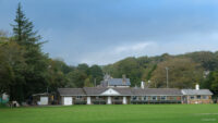 Community sports club building at the far end of a lawn